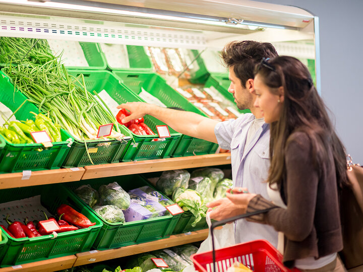 Photo of two people shopping in produce section.